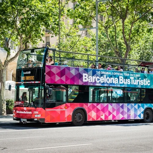 Colourful Barcelona Bus Turístic double-decker at a city stop