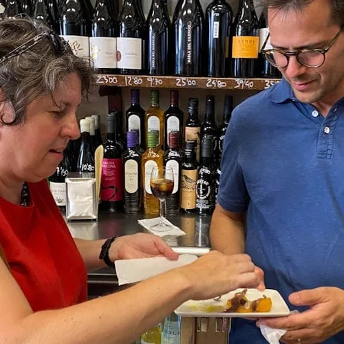 Visitors sharing tapas and wine at a Barcelona bar