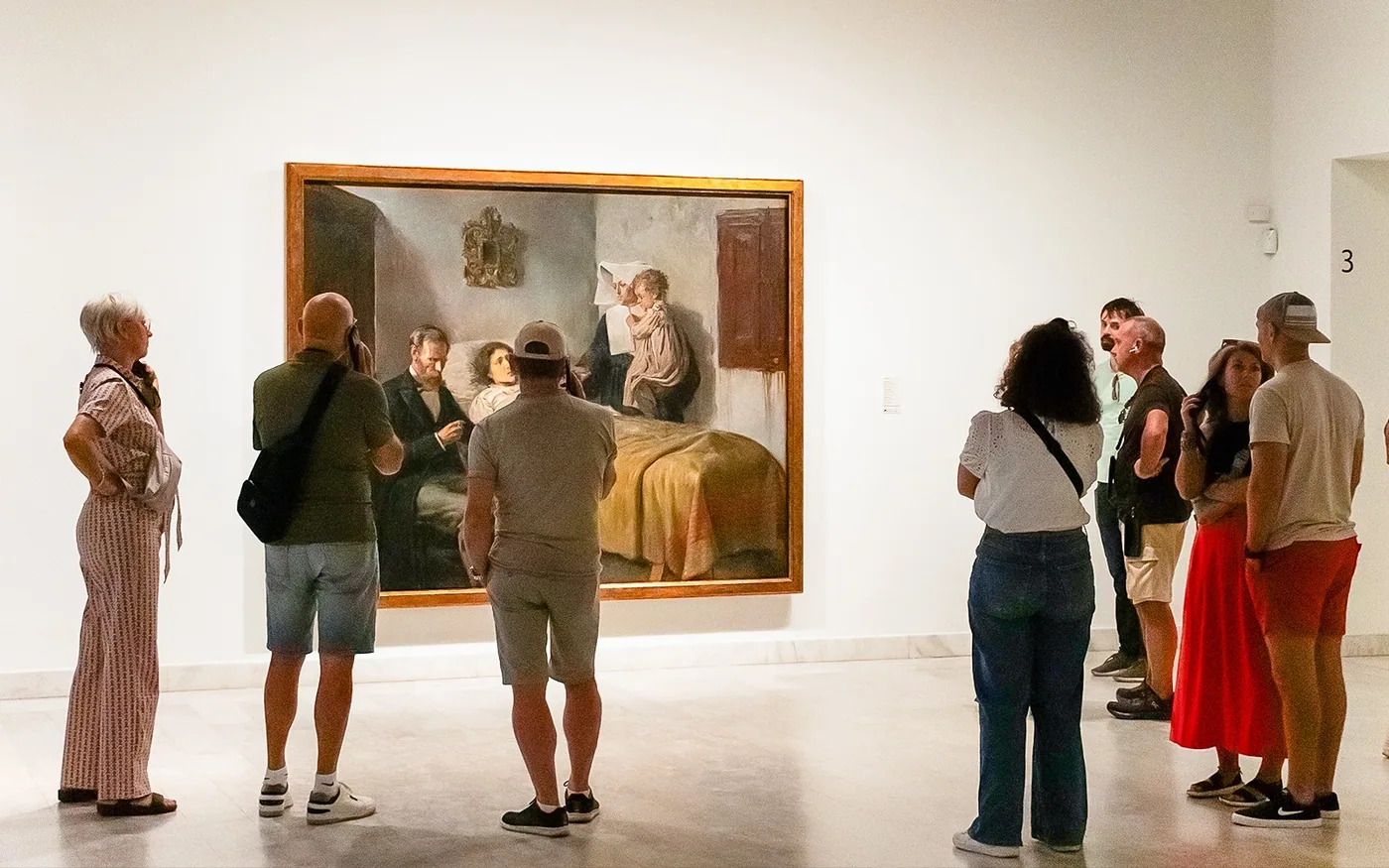 Visitors examining paintings on a guided museum visit in Barcelona